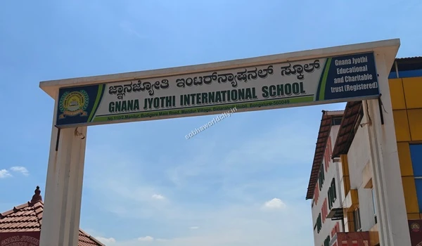 Clear view of the Gnana Jyothi International School signage and trust details located conveniently close to the Sobha World City project