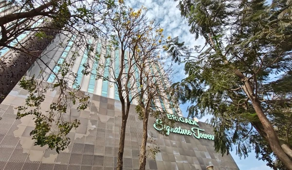 Looking up at the tall commercial buildings representing the thriving business district surrounding the Sobha World City project