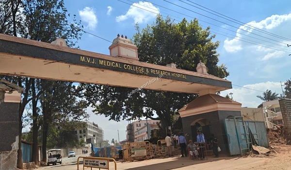 Comprehensive view of the bustling MVJ Medical College and Research Hospital main gate with security personnel near Sobha World City