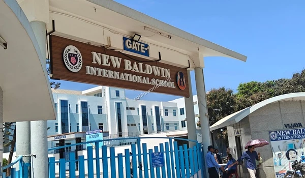 Pedestrians walking near the entrance gate of New Baldwin International School located in the vicinity of Sobha World City