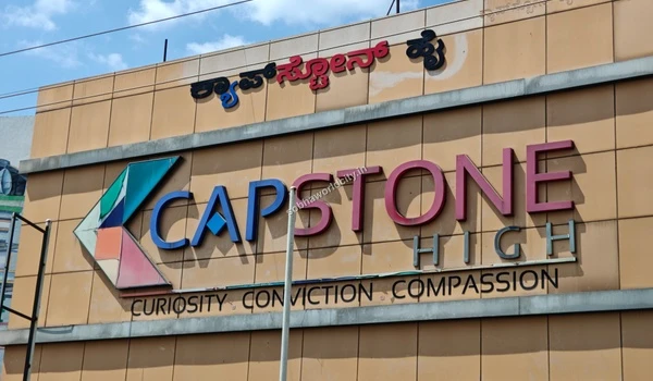 Close-up view of the Capstone High signage and logo, a prominent school serving the educational needs of the Sobha World City area.