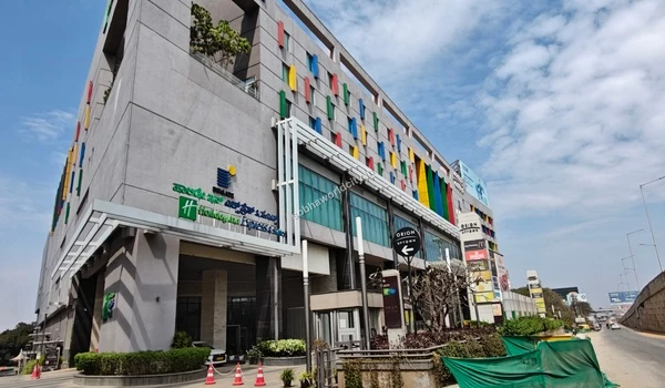 Pedestrian entrance and dedicated drop-off zone of a bustling commercial hub conveniently located near Sobha World City