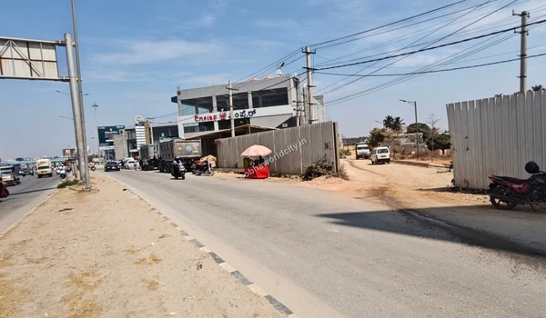 Daytime view of the primary commuter route along Old Madras Road demonstrating the easy approach and wide roads leading to the Sobha World City gateway.