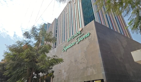 Trees framing the Brigade Signature Towers, a major corporate office space located a short drive from Sobha World City