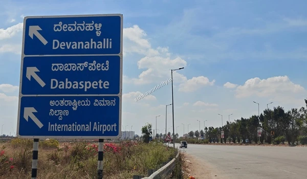 Highway signage pointing towards Devanahalli, showcasing the strategic location and effortless commute options available near Sobha World City