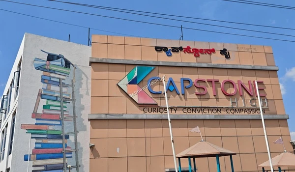 Prominent signage and building of Capstone High, showcasing the top-tier educational hubs accessible within a short drive from Sobha World City.