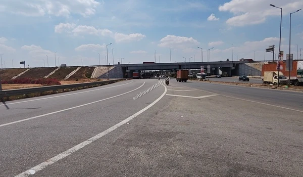 A strong elevated overpass structure handling heavy transit, ensuring local roads below remain uncongested for Sobha World City access.