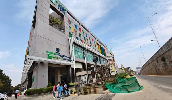 Sign boards indicating multiplex cinemas and electronic stores providing top-tier entertainment options close to Sobha World City