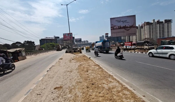 The well-maintained asphalt road at the project entrance providing seamless transit to KR Puram