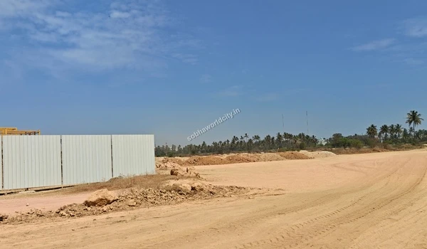 Large piles of excavated dirt and soil gathered along the wide sandy terrain at the Sobha World City site