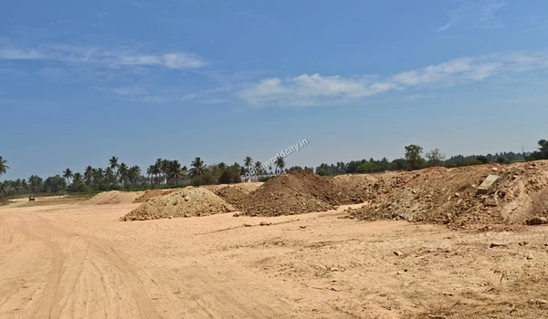 Large excavated earth mounds piled up along the cleared terrain during the groundwork phase at Sobha World City