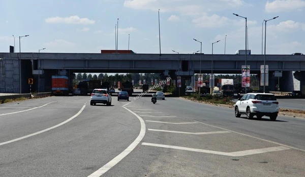 An elevated expressway bridge allowing uninterrupted cross-traffic flow above the arterial roads near the Sobha World City township.