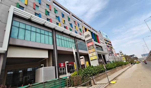 A large advertising billboard showcasing fine dining restaurants and premium barbecue outlets accessible from Sobha World City