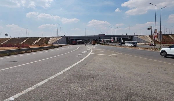 Wide roadways comfortably accommodating both commercial freight and local passenger transit near the strategic Sobha World City location.