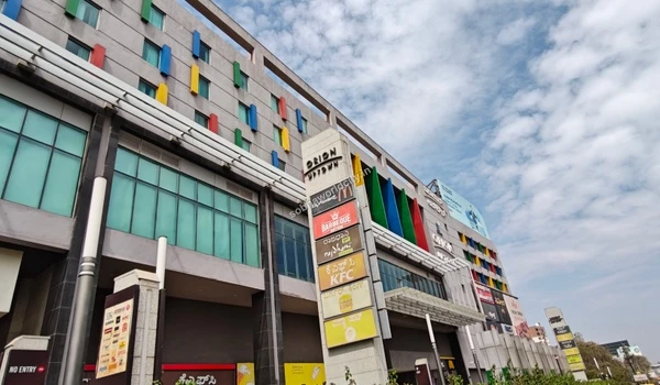 A vibrant exterior view showcasing popular global fast-food chains including KFC, Burger King, and McDonald's, offering quick dining options near Sobha World City