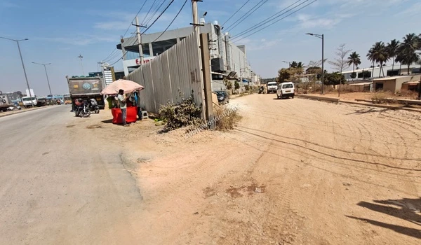 The diversion point from KR Puram Hoskote Road into the Sobha World City property showing immediate and direct highway access for future residents.