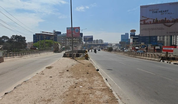 Clear view of the wide highway leading towards Hoskote from the entrance of Sobha World City, showcasing excellent road infrastructure.