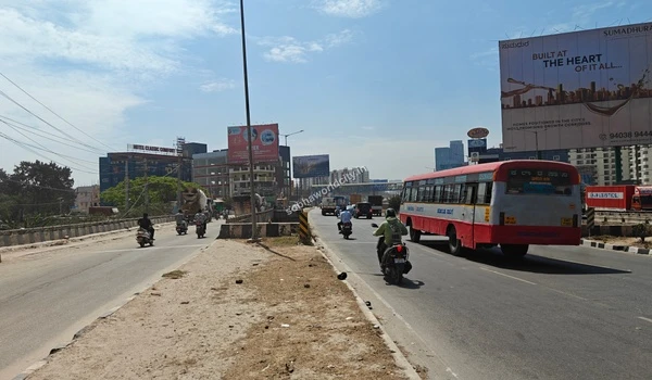 View of vehicles including a local bus heading on the multi-lane highway towards Hoskote, ensuring fast and easy travel from Sobha World City.