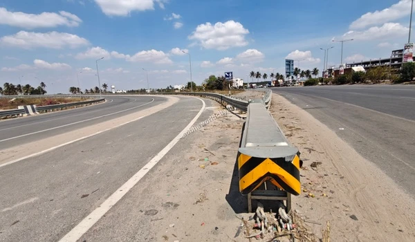 Wide view of the highway junction where the ramp heads to Hosur Road and the main road continues to Kolar, close to Sobha World City.