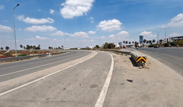 A clear view of the straight highway route heading towards Kolar from the Hosur Road junction near Sobha World City.