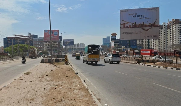 A wide panoramic view of the expansive road leading directly from the Sobha World City entrance towards KR Puram