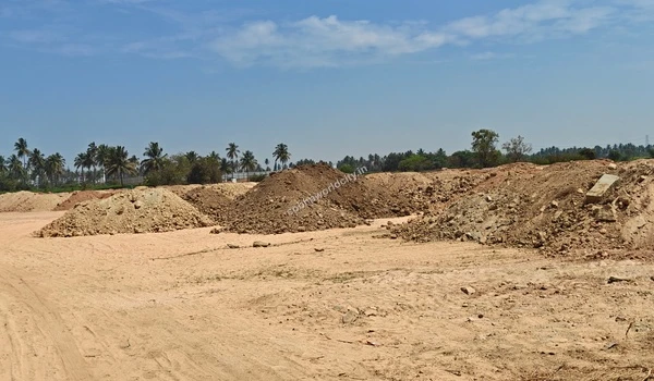 Large heaps of brown rocky earth gathered during the extensive site excavation at Sobha World City