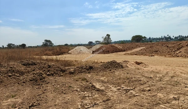 Construction materials including soil and gravel dumped on-site for ground leveling at Sobha World City