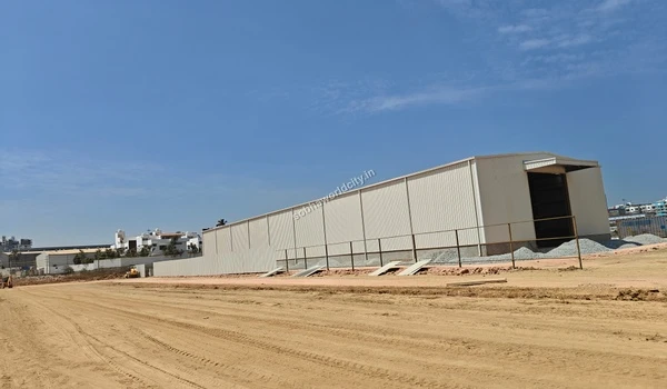 Side perspective of the white temporary storage shed erected for materials at the Sobha World City project