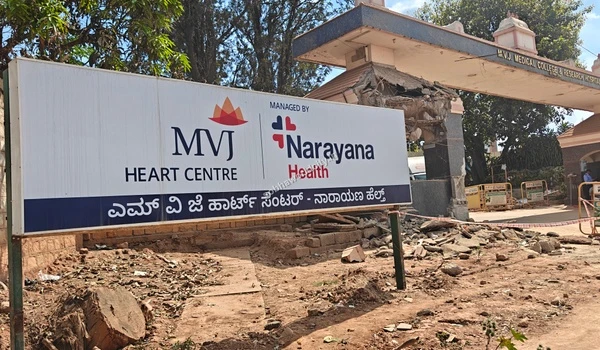 Wide exterior view of the MVJ Medical College and Research Hospital gate featuring the prominent Heart Centre board close to Sobha World City