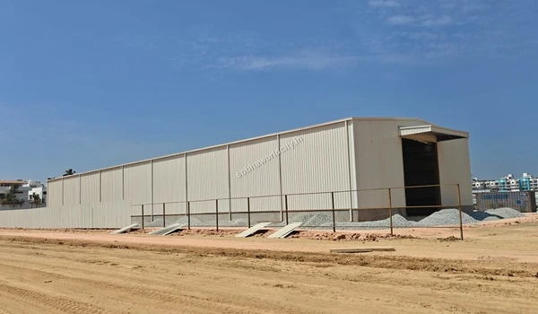 Large temporary metal storage facility and shed built for storing construction materials at Sobha World City