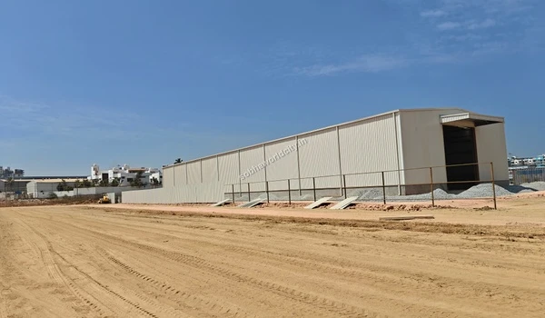 Temporary metal warehouse structure erected for material storage at the Sobha World City site