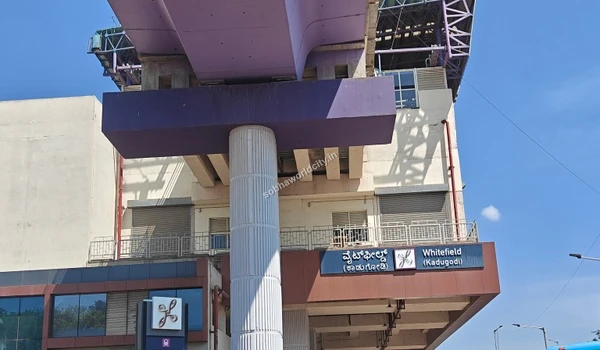 Comprehensive view of the modern metro viaduct and station exterior blending public transit with the growing Sobha World City neighborhood