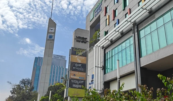 Signage tower showing multiplex cinema and electronics stores like Reliance Digital near Sobha World City