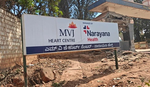 Signage of MVJ Heart Centre managed by Narayana Health with the main entrance gate visible in the background near Sobha World City