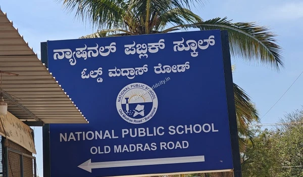 Prominent signboard of National Public School located on Old Madras Road, a premier educational institution close to Sobha World City.