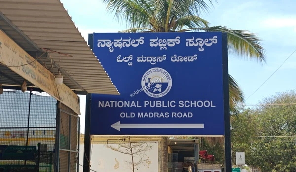 Clear view of the National Public School sign on Old Madras Road, ensuring quality education access for families at Sobha World City.