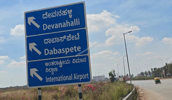 Key navigational signs for North Bangalore destinations including Devanahalli, easily accessible from the Sobha World City location.