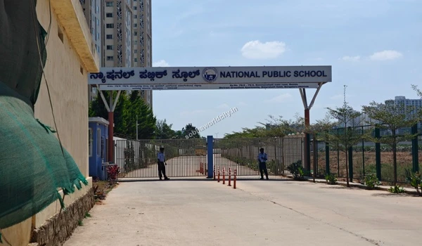 The gated entrance of National Public School on Old Madras Road, highlighting the organized infrastructure around Sobha World City.