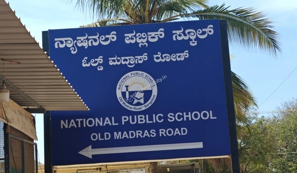 View of the National Public School campus directional board on OMR, highlighting top-tier schooling options for Sobha World City residents.