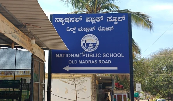 Directional sign for National Public School on Old Madras Road, demonstrating the excellent social infrastructure surrounding Sobha World City.