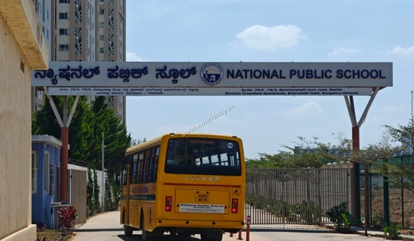 School bus entering the National Public School premises on Old Madras Road, ensuring safe transport for students near Sobha World City.