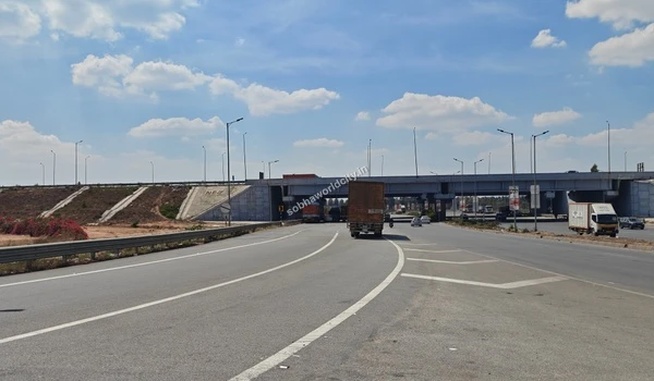 The solid concrete overpass bridge facilitating seamless cross-traffic movement without disrupting local travel to Sobha World City.