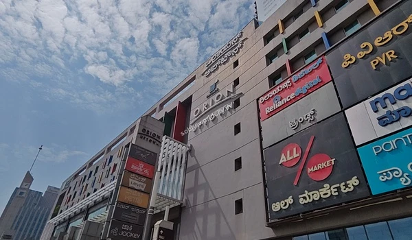 Close up view of the mall entry directory displaying premium clothing and footwear brands situated near the Sobha World City residential area