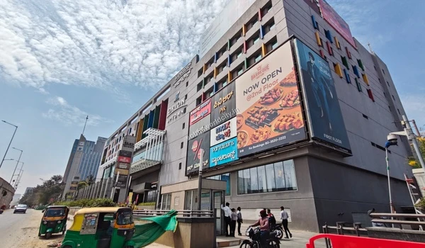Exterior view of a premium shopping mall near Sobha World City featuring dining options like Barbeque Nation