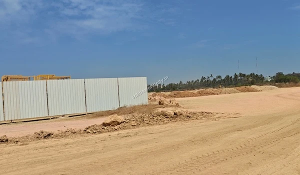 Exterior view of the primary white metal storage warehouse erected at the Sobha World City project site