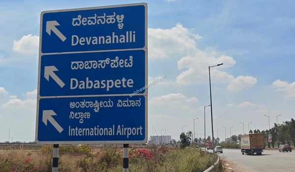 Roadside signage offering regional guidance to Devanahalli and the International Airport for commuters starting from Sobha World City.
