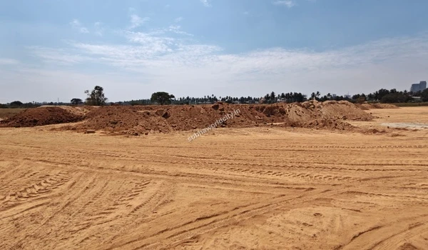 Extensive earthworks and tracking on the sandy terrain at the Sobha World City project site
