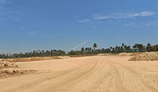 Front entrance of the long white site storage unit located along the sandy access road at Sobha World City