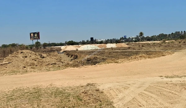 Uneven ground with an excavated trench and various soil mounds near a billboard at the Sobha World City project site
