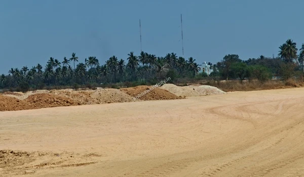 Excavated soil and rock piles lining the edge of the leveled ground at Sobha World City